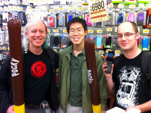 Mitch, Elliot, and Matt at Don Quixote, Shibuya with giant inflatable Pocky sticks